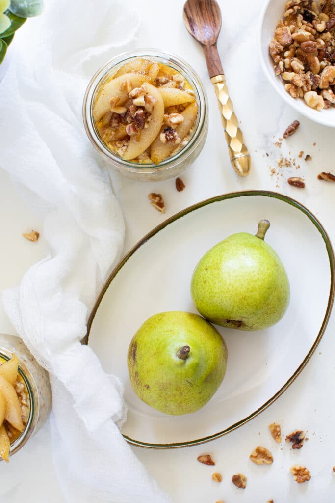 Vanilla Overnight Oats and Maple Spiced Pears next to a plate of pears.