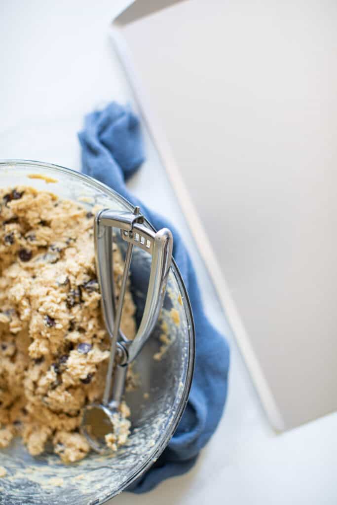 Peanut Butter Oatmeal Chocolate Chip Cookie dough in a glass bowl.