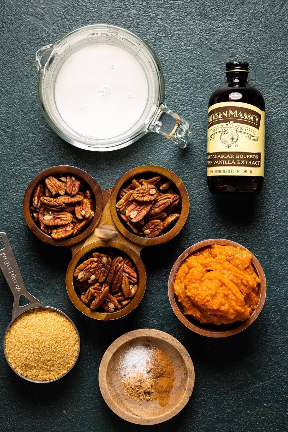 Ingredients for Vegan Pumpkin Pecan Sticky Buns including vanilla extract, pecans, and pumpkin puree