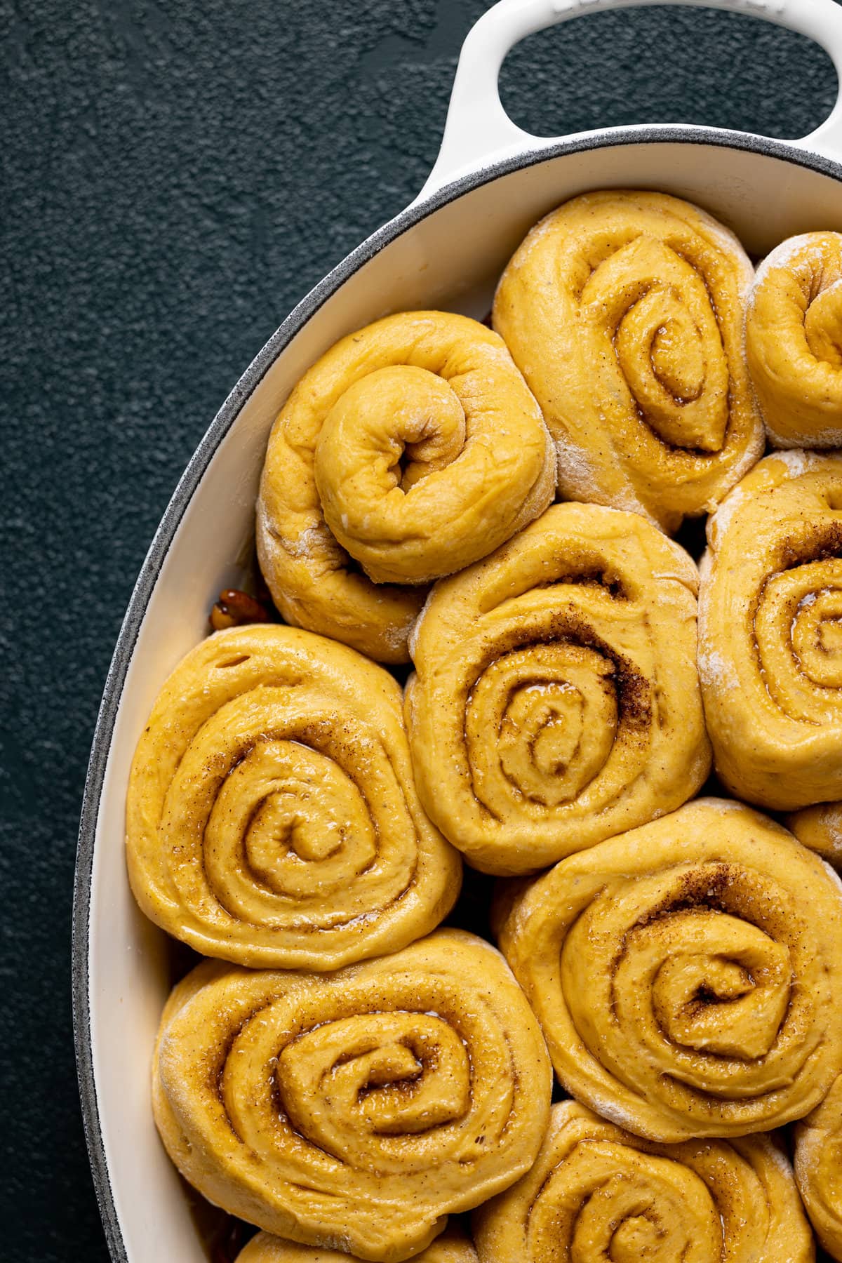 Uncooked Vegan Pumpkin Pecan Sticky Buns in a baking pan