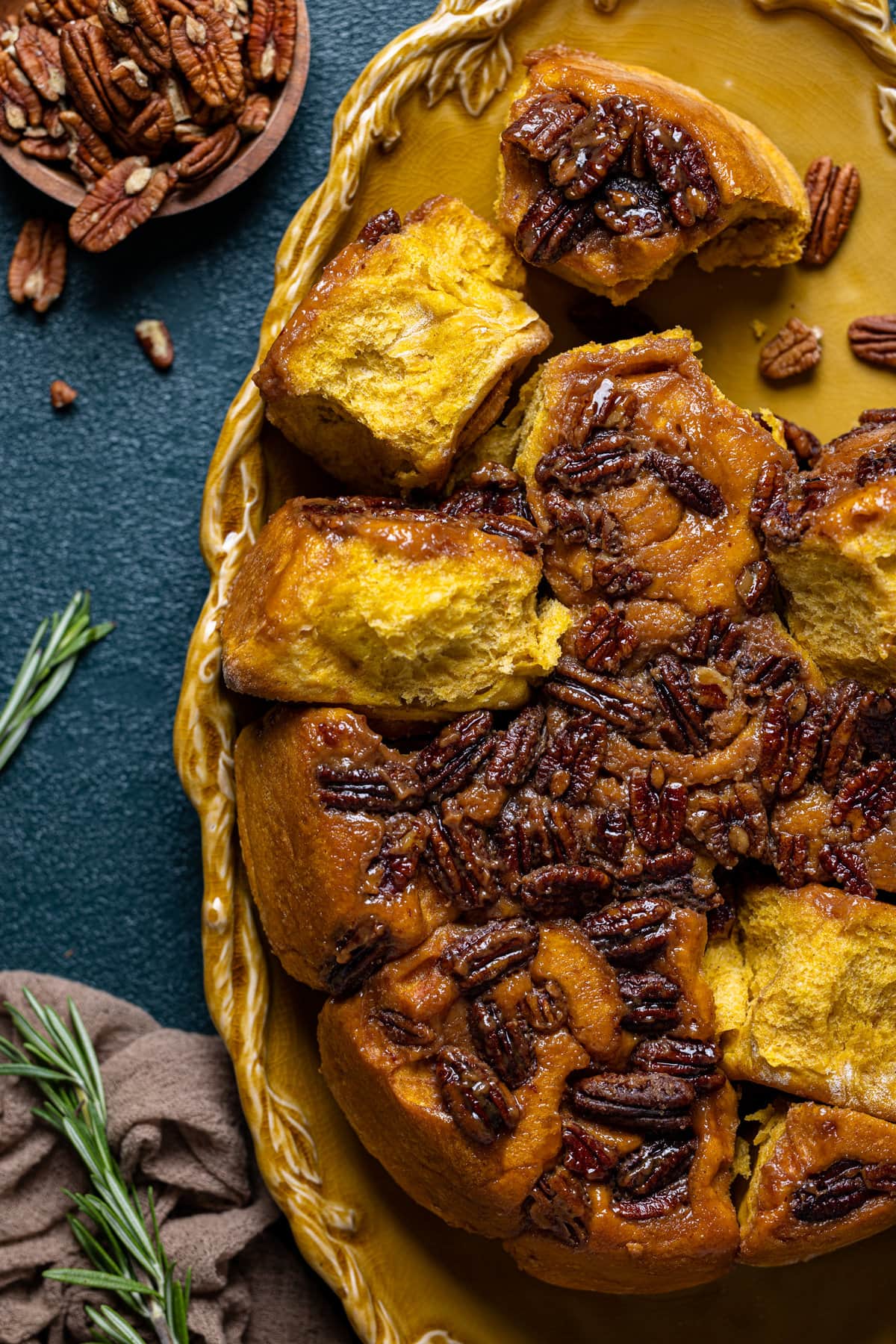 Baking pan of Vegan Pumpkin Pecan Sticky Buns missing a few buns