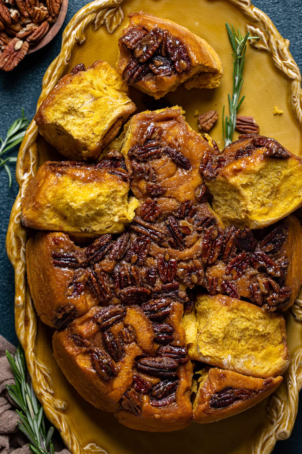 Baking pan of Vegan Pumpkin Pecan Sticky Buns missing a few buns