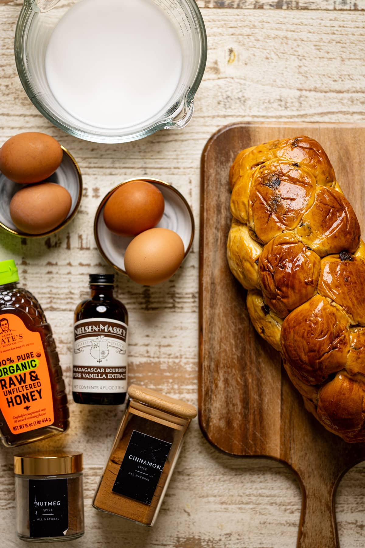 Ingredients for Balsamic Strawberry Brioche French Toast including eggs, honey, vanilla extract, and cinnamon