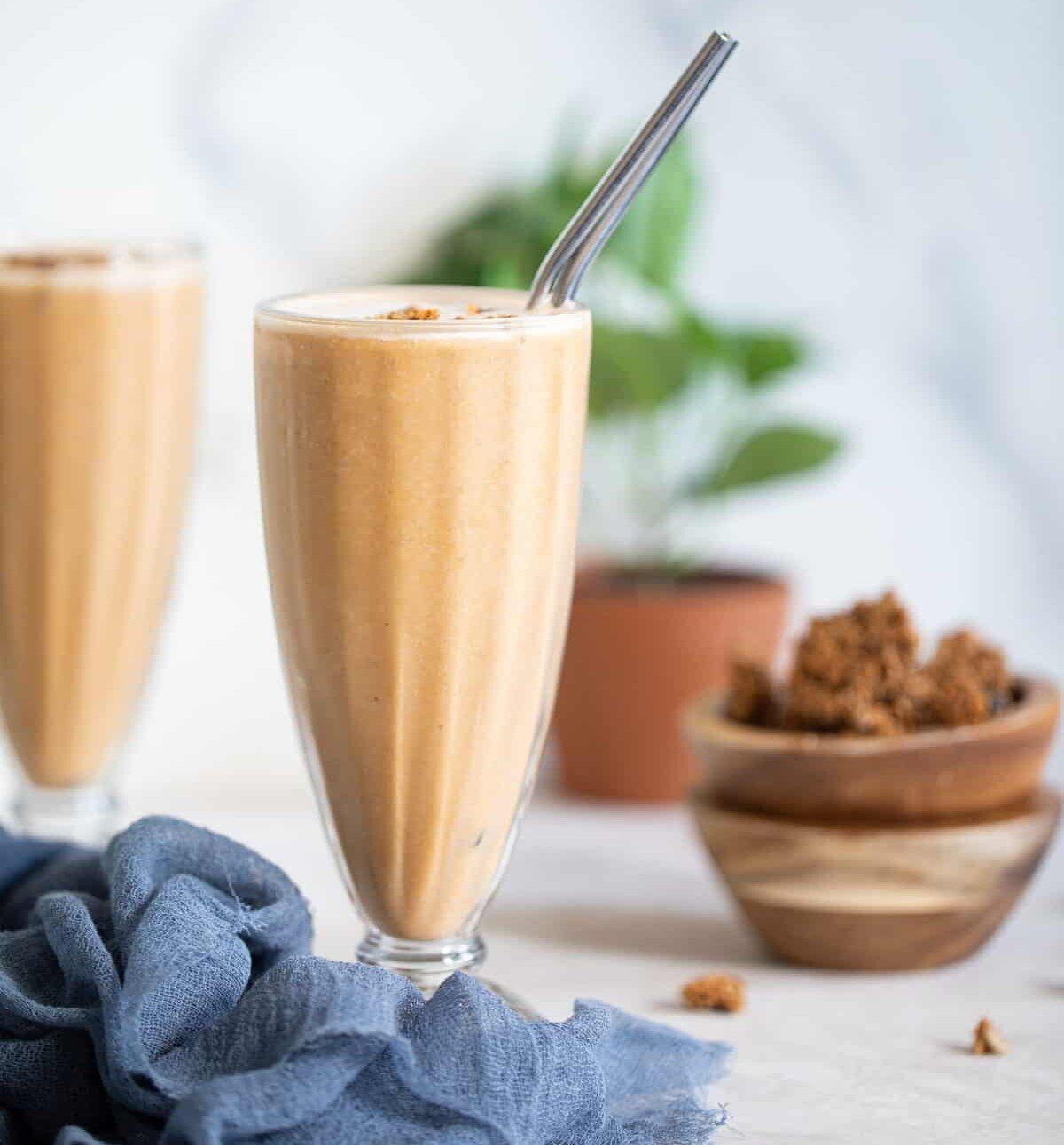 Sweet Potato Breakfast Smoothie in a tall glass with metal straw.