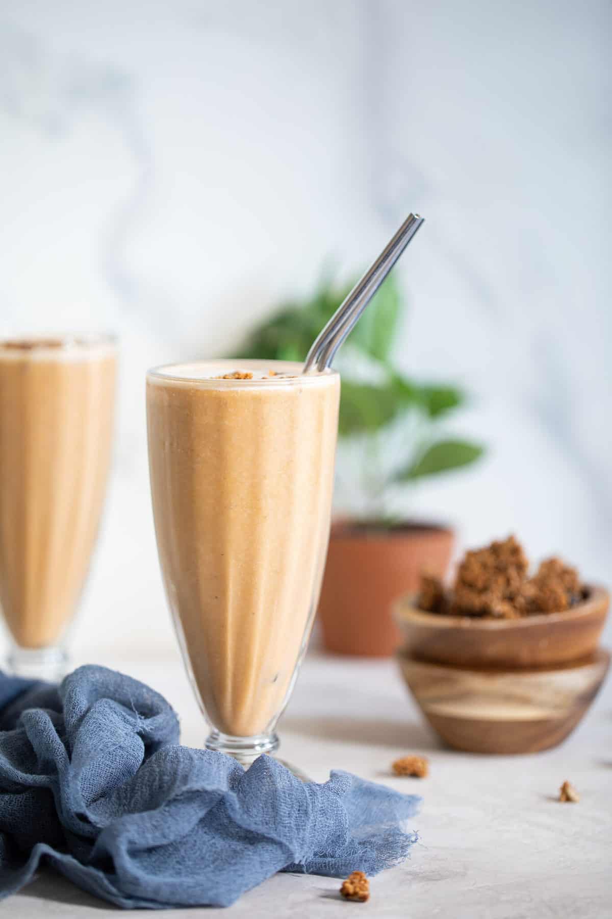 Sweet Potato Breakfast Smoothie in a tall glass with metal straw.