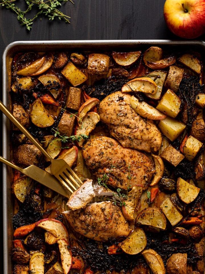 Sheet Pan of Maple Apple Chicken and Veggies with gold silverware.