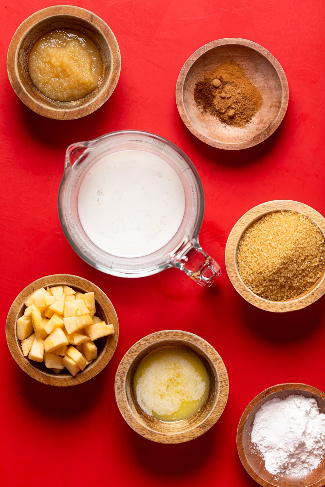 Bowls of ingredients including apple pieces, cinnamon, and brown sugar.