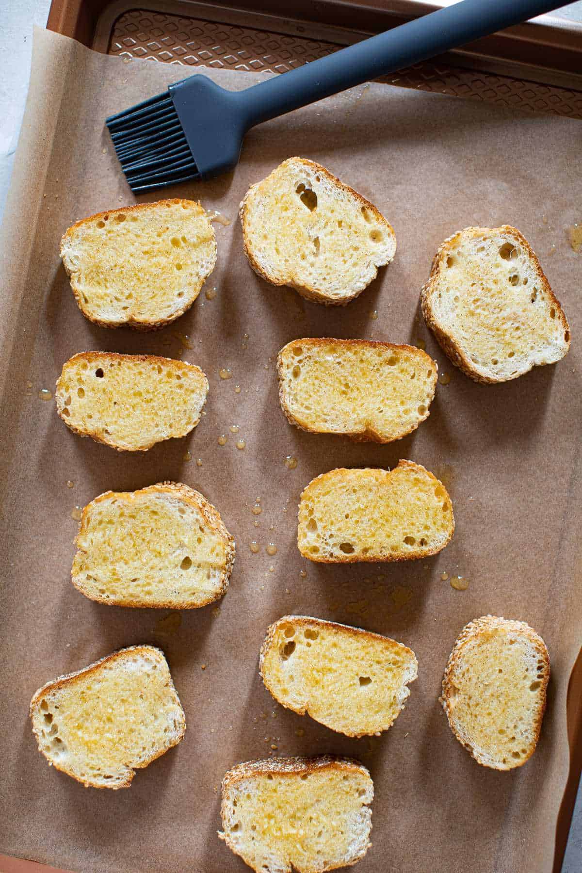 Fall Harvest Apple Bacon Crostini on a parchment-lined baking sheet.