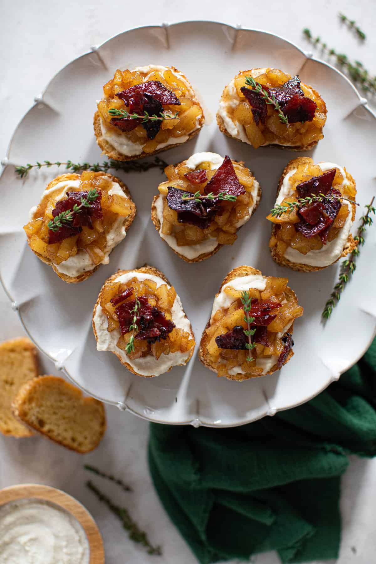 White plate of Fall Harvest Apple Bacon Crostini.