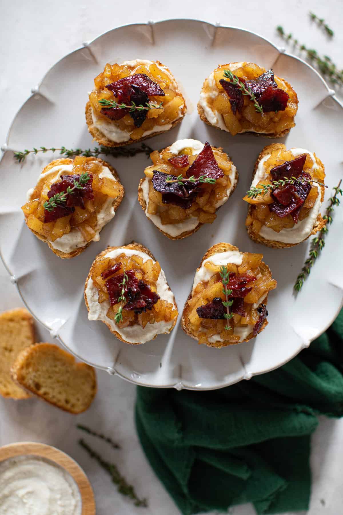 White plate of Fall Harvest Apple Bacon Crostini.