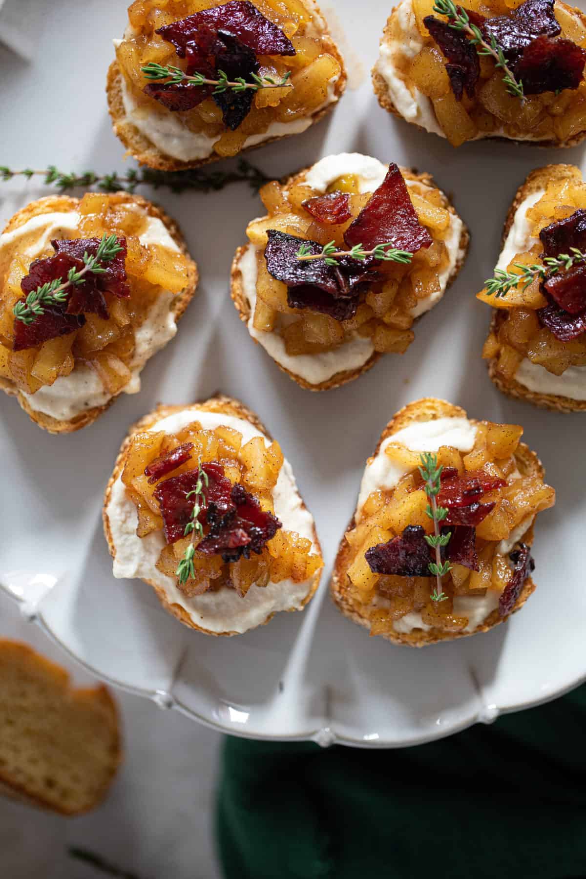 Fall Harvest Apple Bacon Crostini on a white plate.