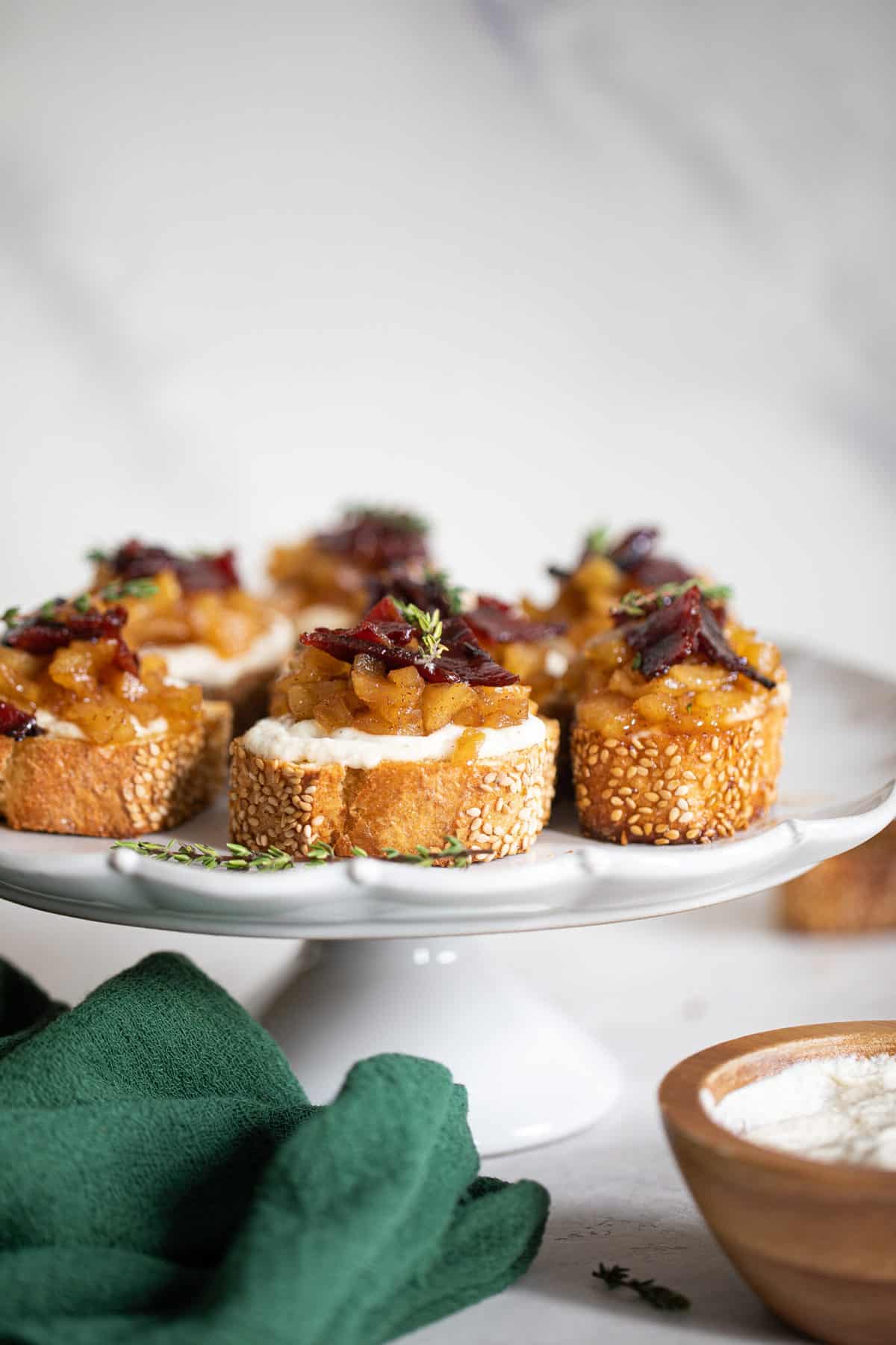 White platter of Fall Harvest Apple Bacon Crostini.