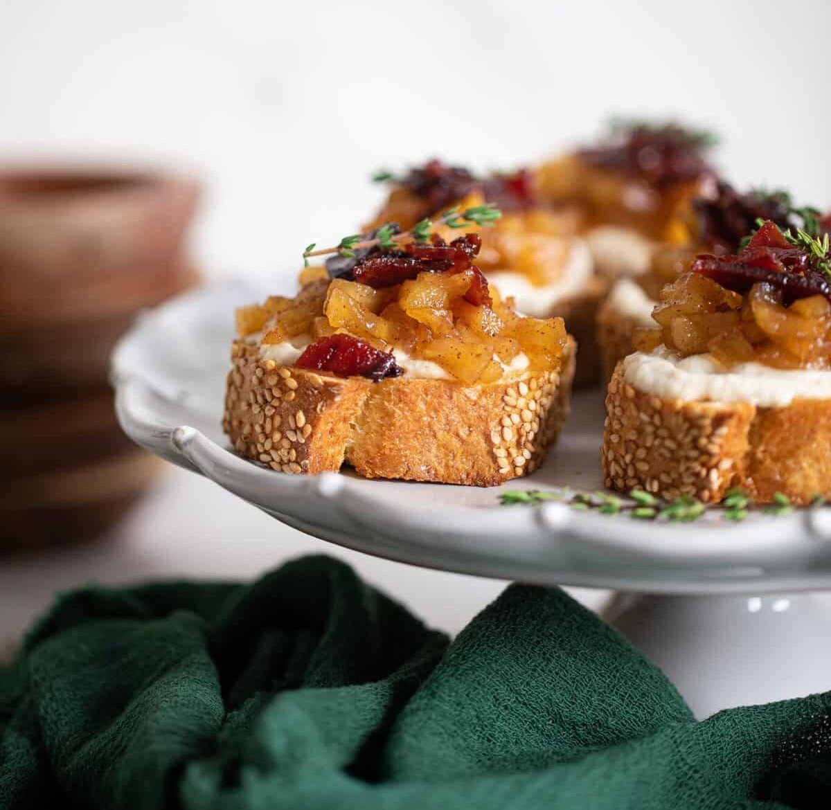 Fall Harvest Apple Bacon Crostini piled high with apple topping.