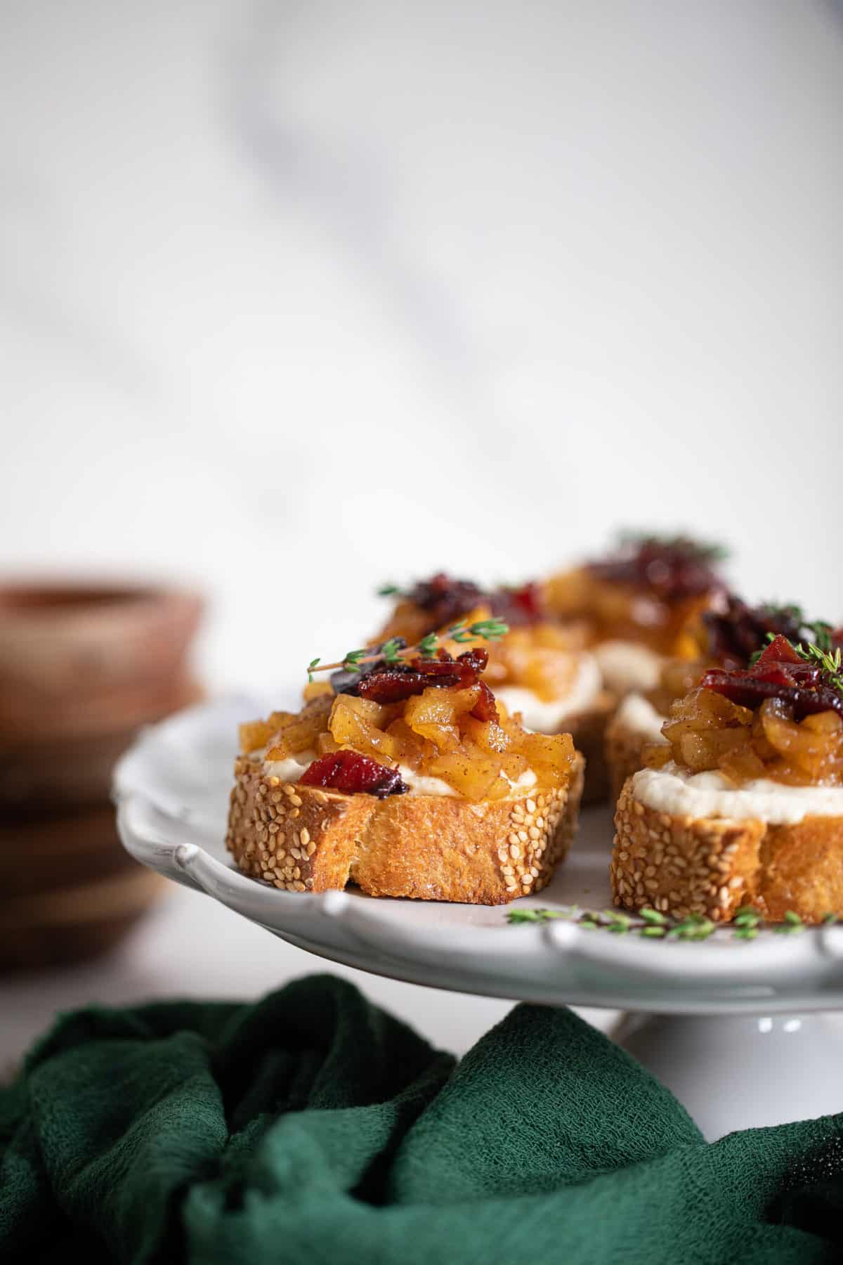 Fall Harvest Apple Bacon Crostini piled high with apple topping.