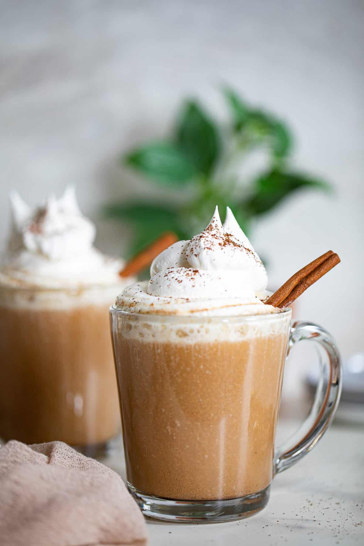 Two glass mugs of Warm Apple Chai Latte.