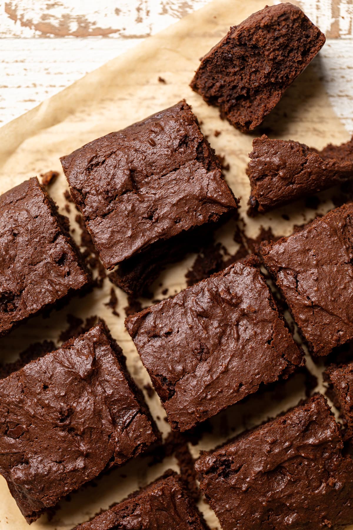 Fudgy Vegan Brownie Squares on parchment paper.