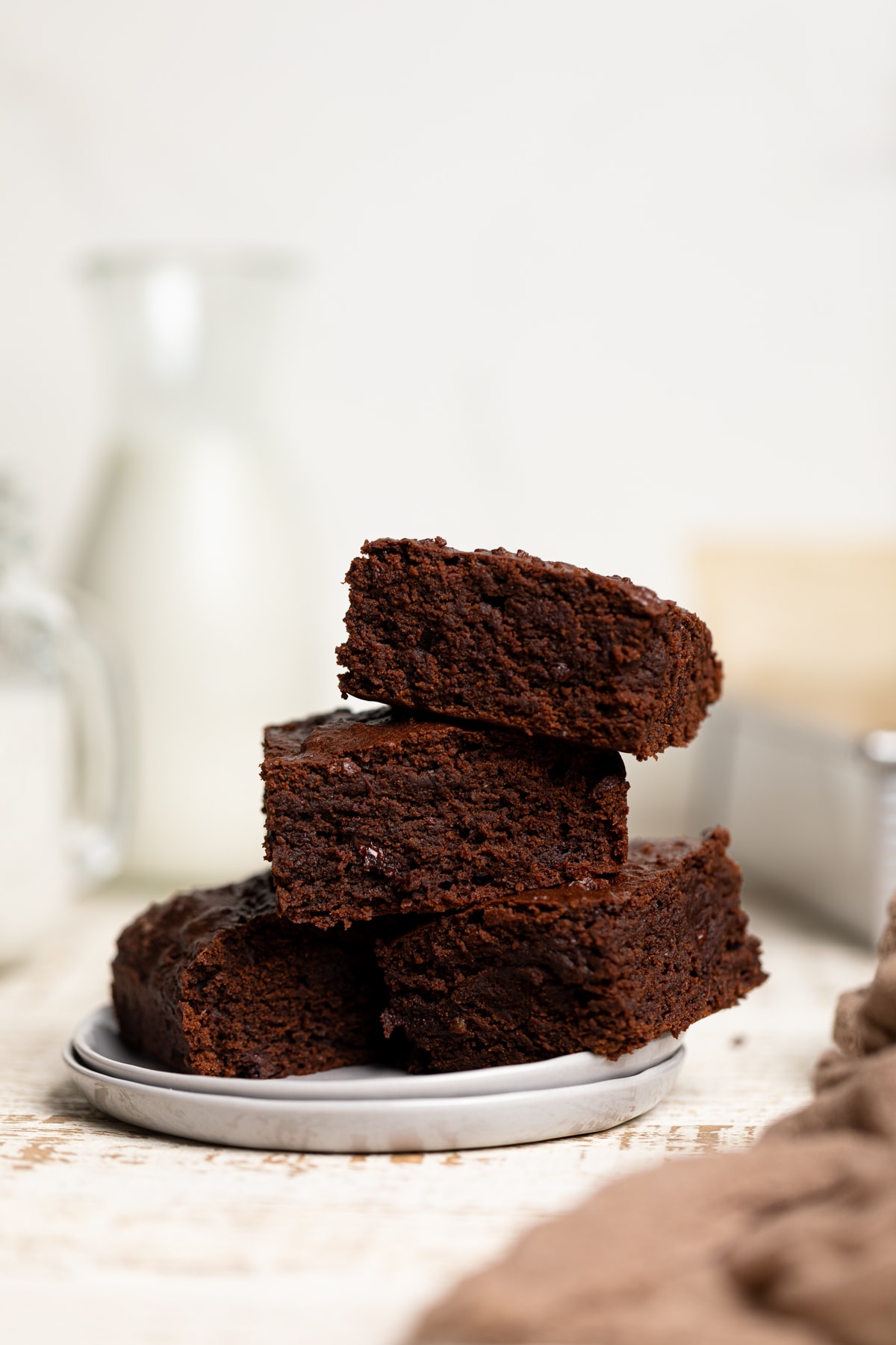 Small plates topped with Extra Fudgy Vegan Brownies.