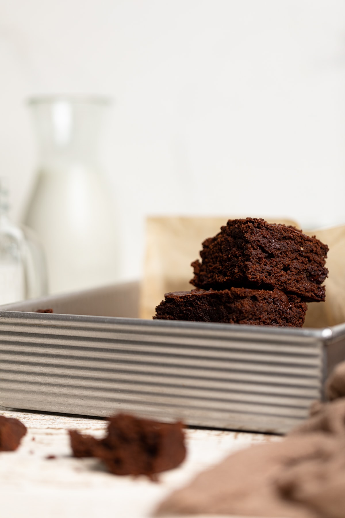 Metal pan with a pile of Fudgy Vegan Brownies.