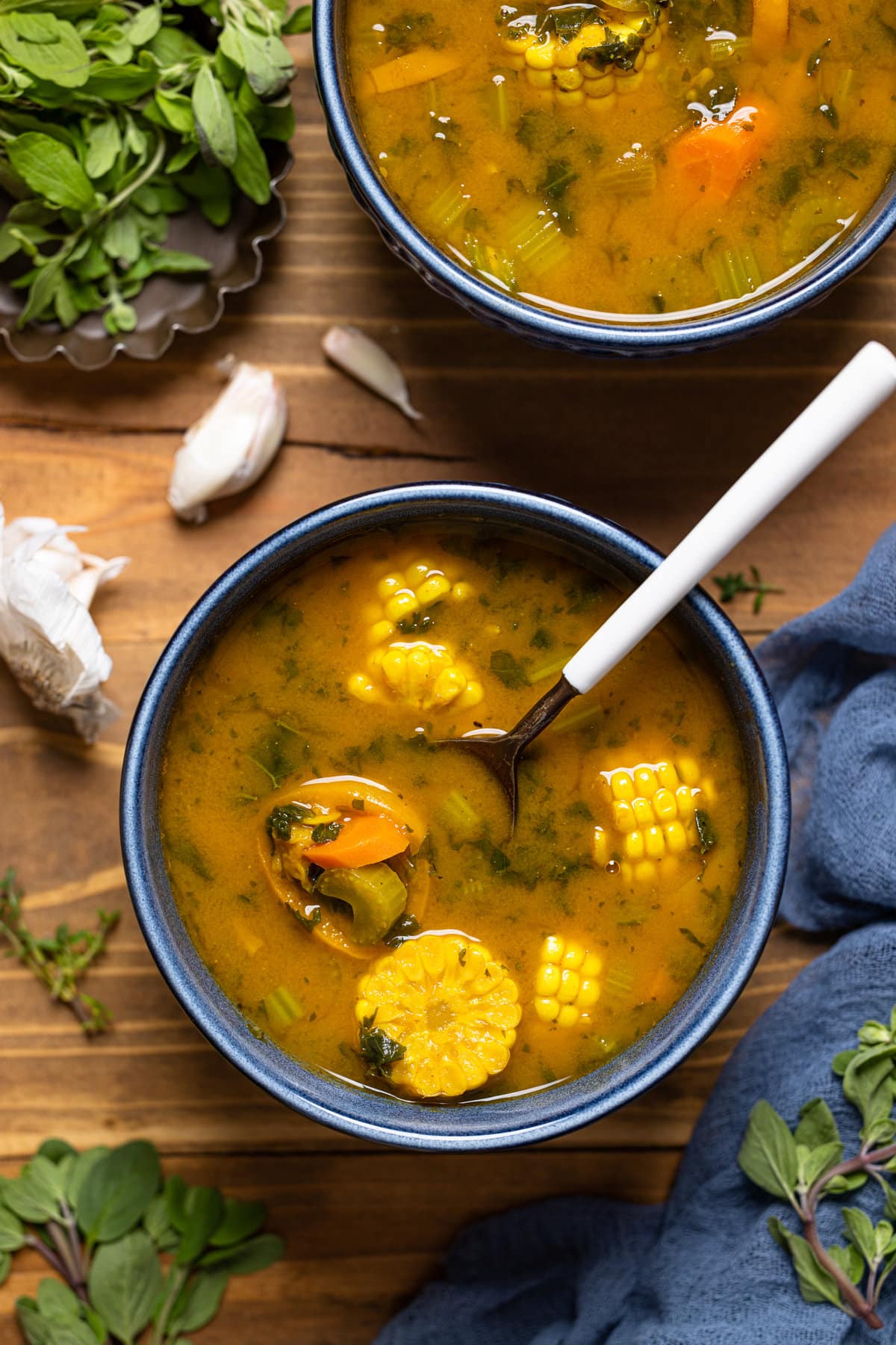 Overhead shot of a bowl of Sweet Potato Veggie Soup with a spoon