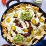 Black Bean and Quinoa Skillet Nachos topped with guacamole.