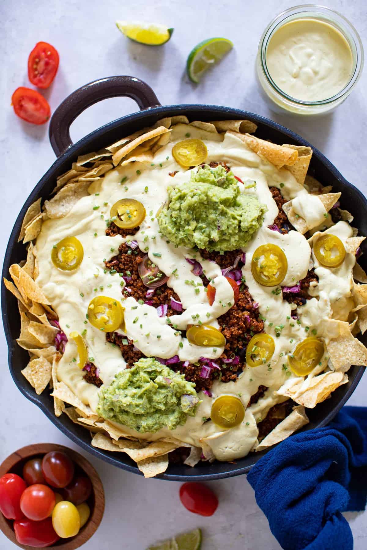 Black Bean and Quinoa Skillet Nachos topped with guacamole.