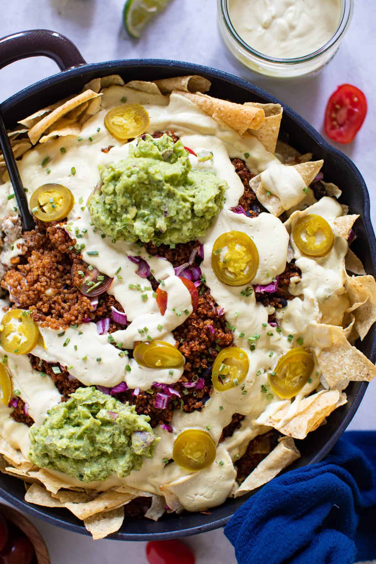 Black Bean and Quinoa Skillet Nachos topped with peppers.