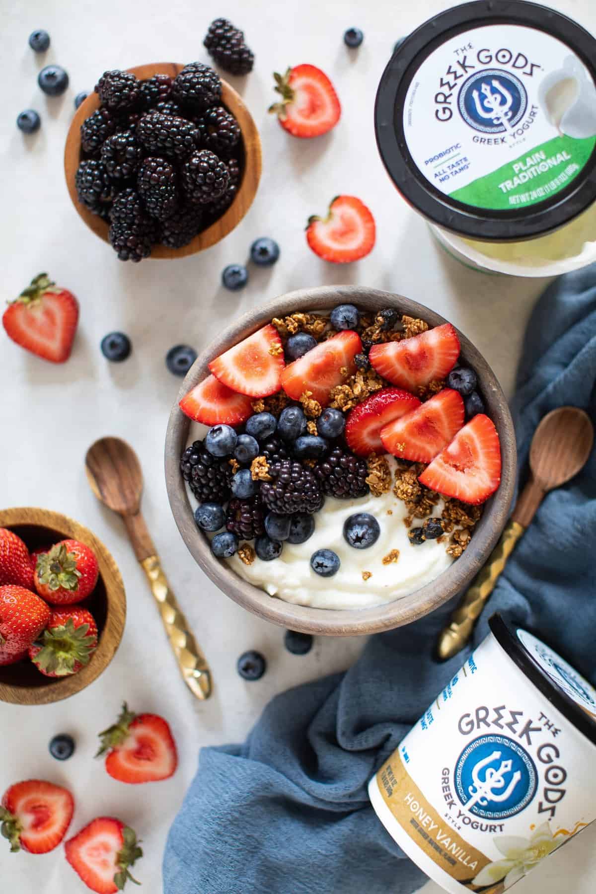 Greek Yogurt Breakfast Bowl, fruit, and Greek Gods yogurt on a table.