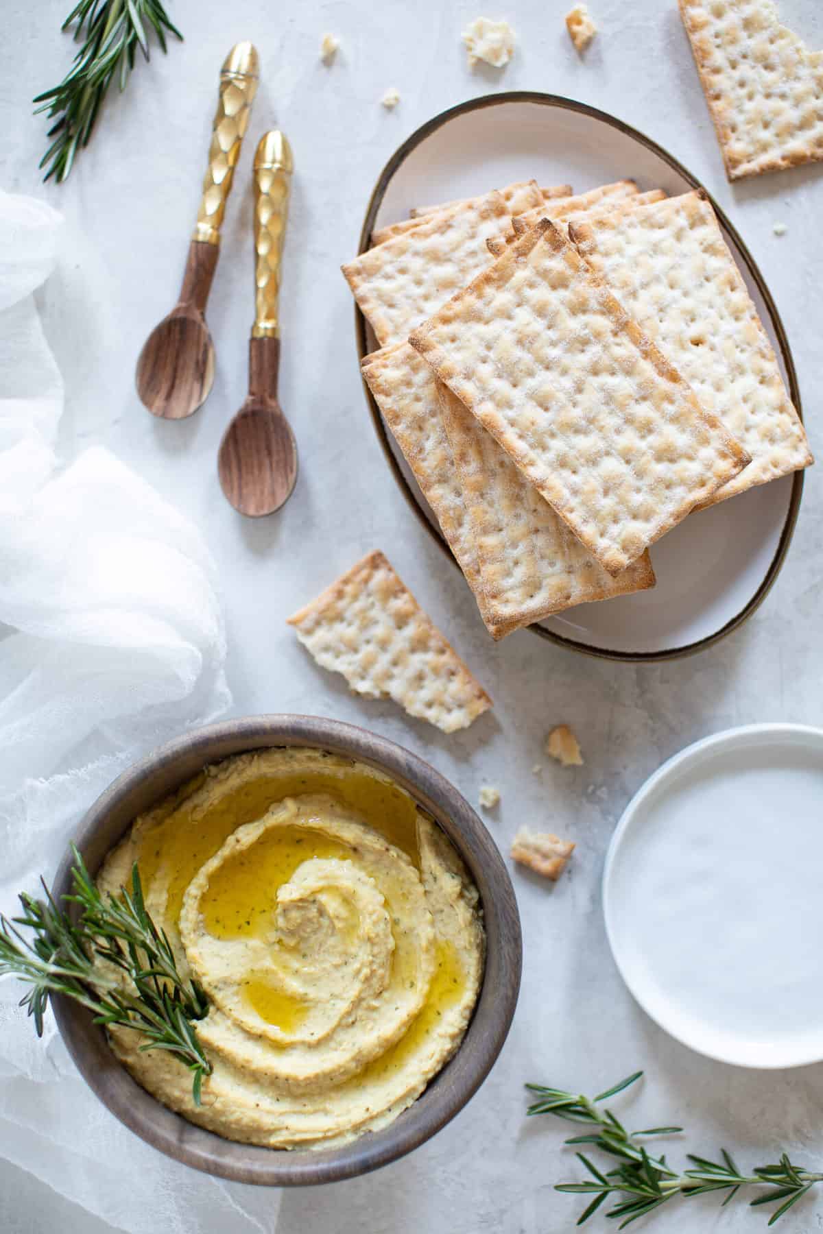 Plate of crackers with a bowl of hummus.