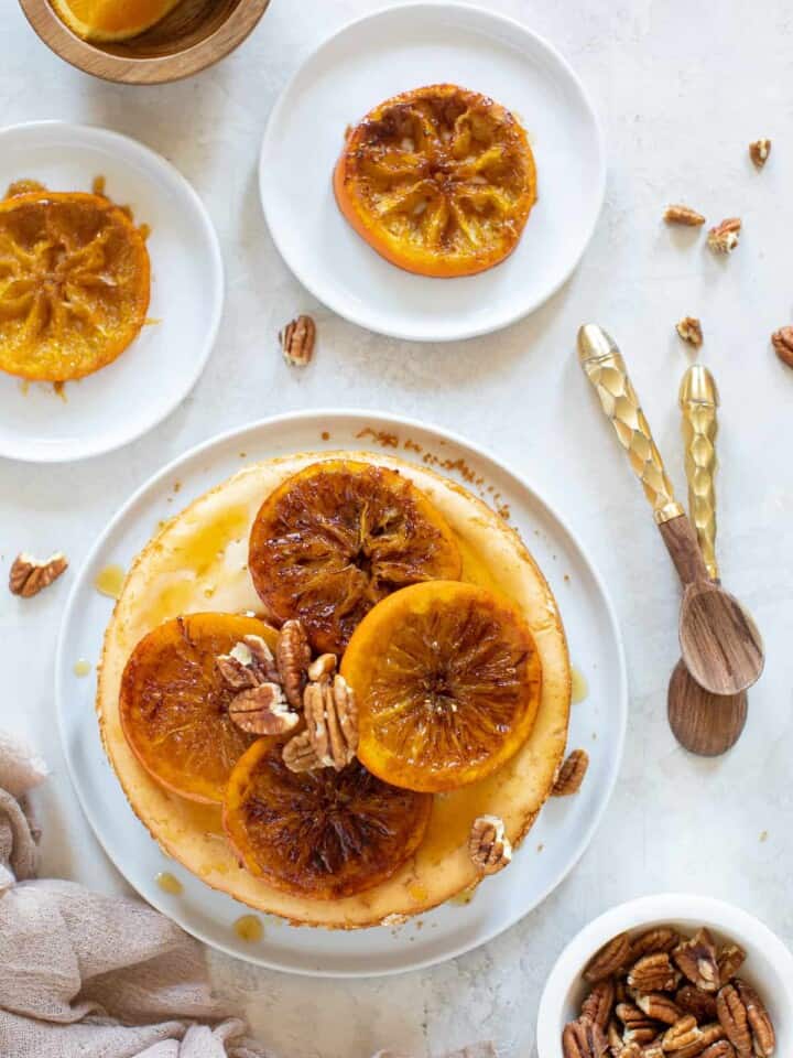 Spiced Orange Cheesecake with Pecan Crust on a white plate.