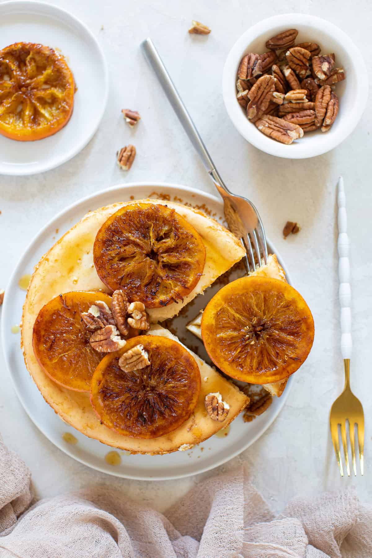 Spiced Orange Cheesecake with Pecan Crust on a plate with a fork.