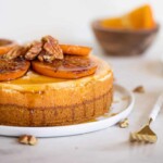 Spiced Orange Cheesecake with Pecan Crust topped with sliced oranges.