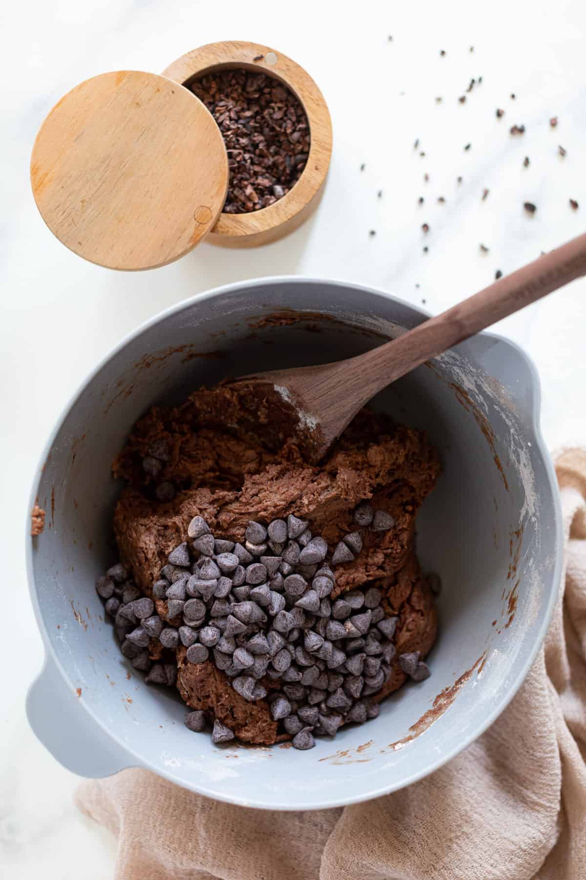 Chocolate chips in a bowl with Vegan Chocolate Bread dough.