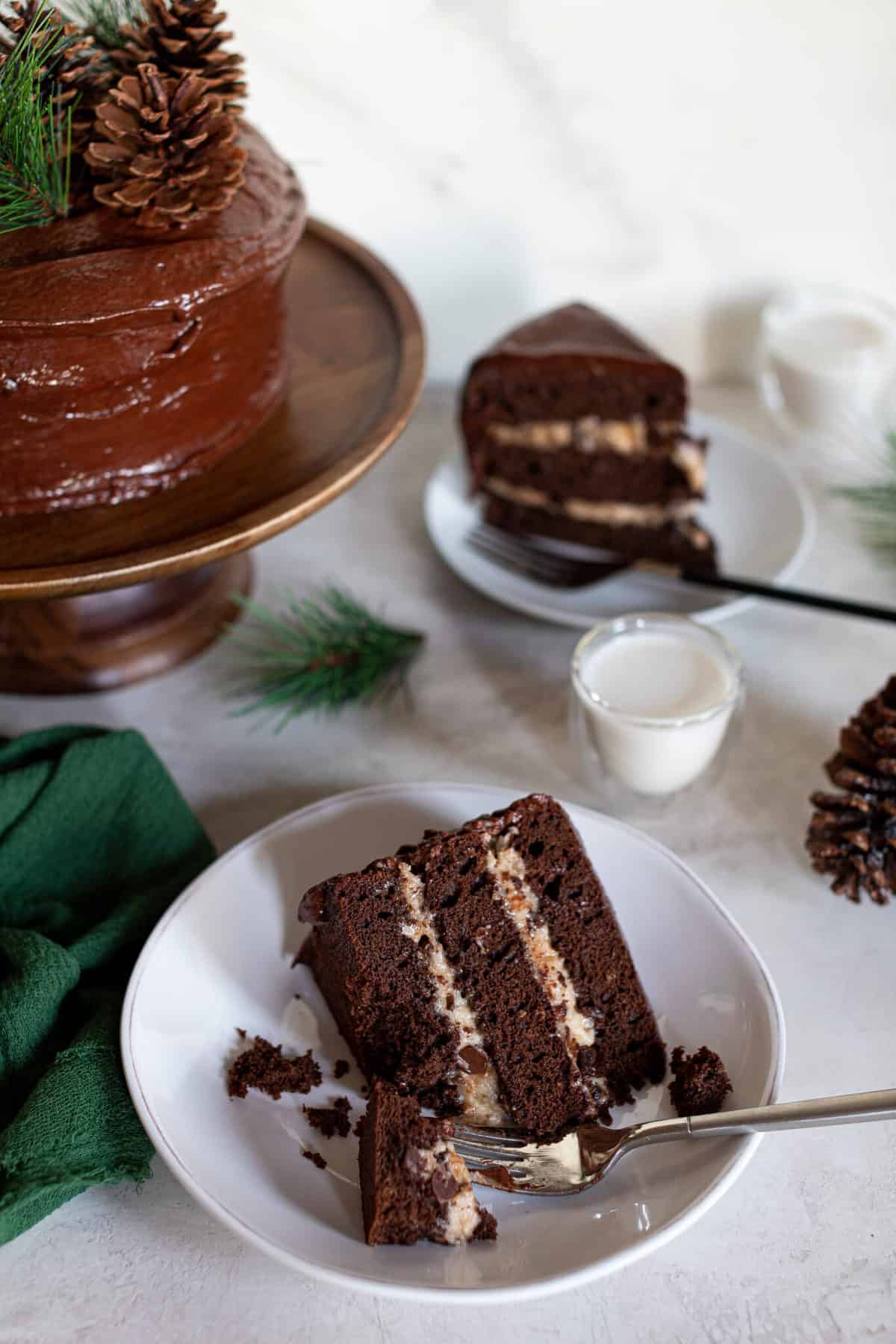 Slices of Vegan Brownie Cookie Dough Cake on small plates.