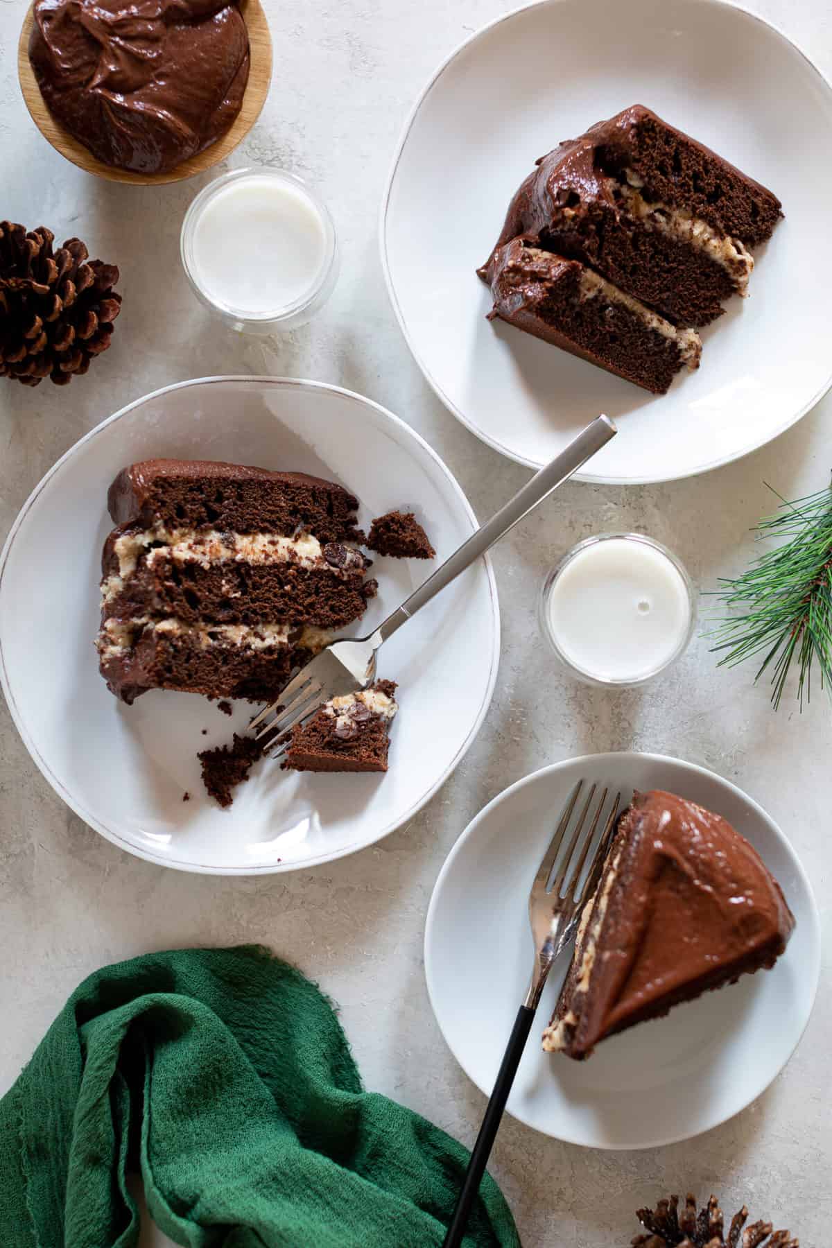 Small plates with slices of Vegan Brownie Cookie Dough Cake.