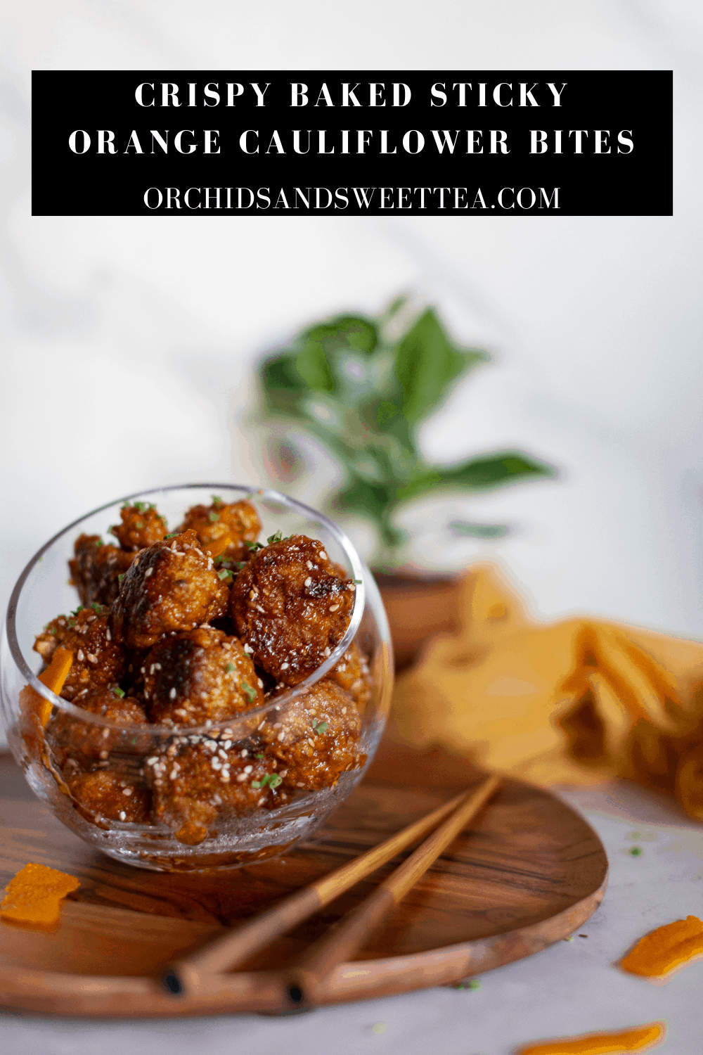 Bowl of food with text \"Crispy Baked Sticky Orange Cauliflower Bites.\"