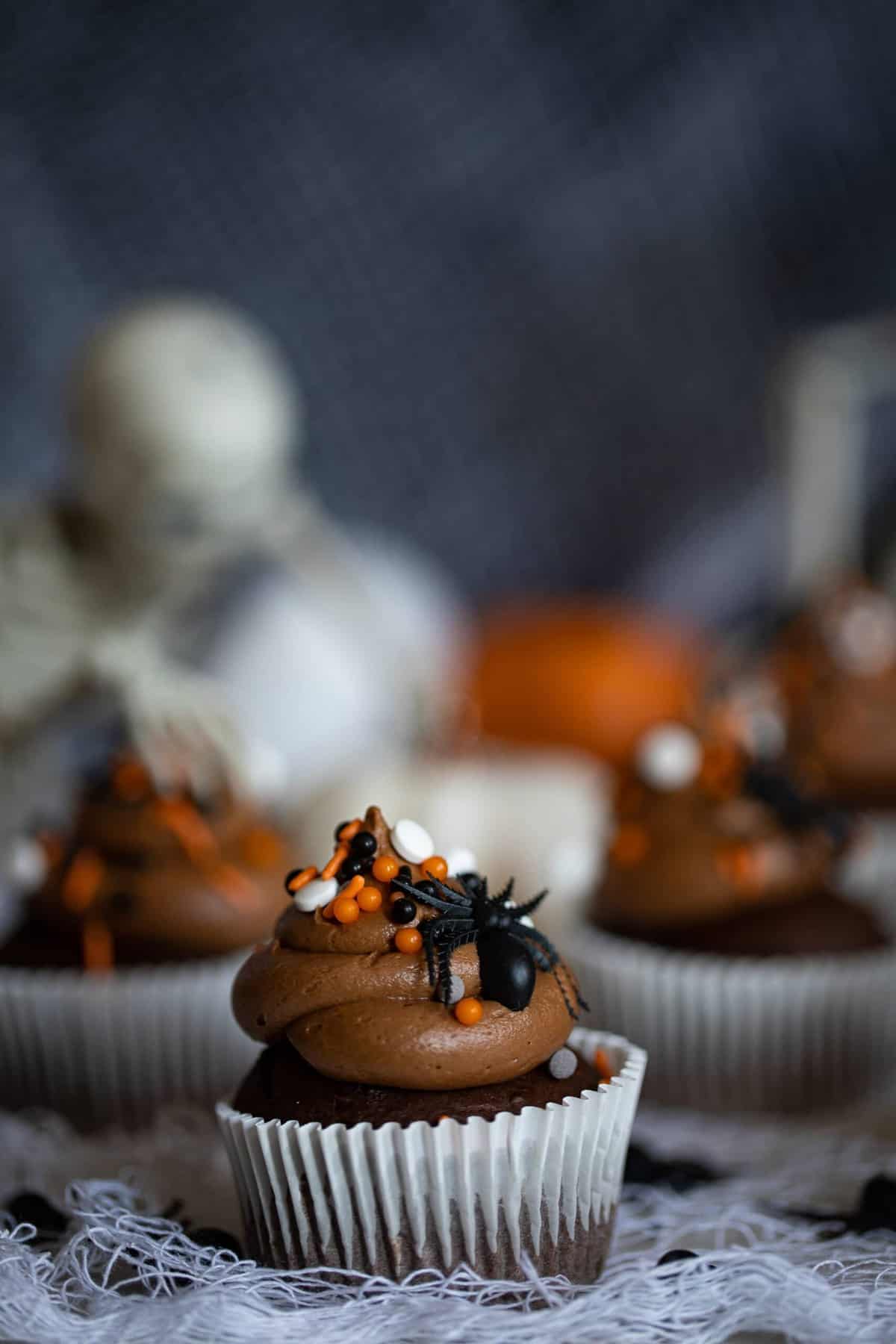Spooky Double Chocolate Cupcakes decorated with spiders.