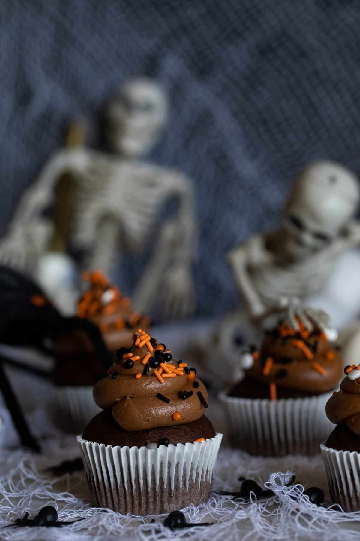 Spooky Double Chocolate Cupcakes in front of skeletons.