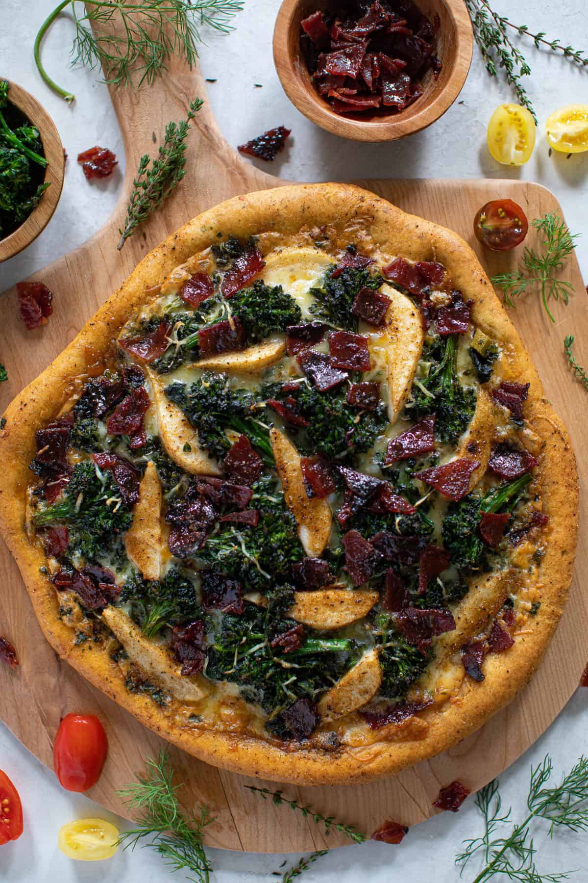 Fall Harvest Pizza topped with Apples, Candied Bacon, Broccolini, and Kale.