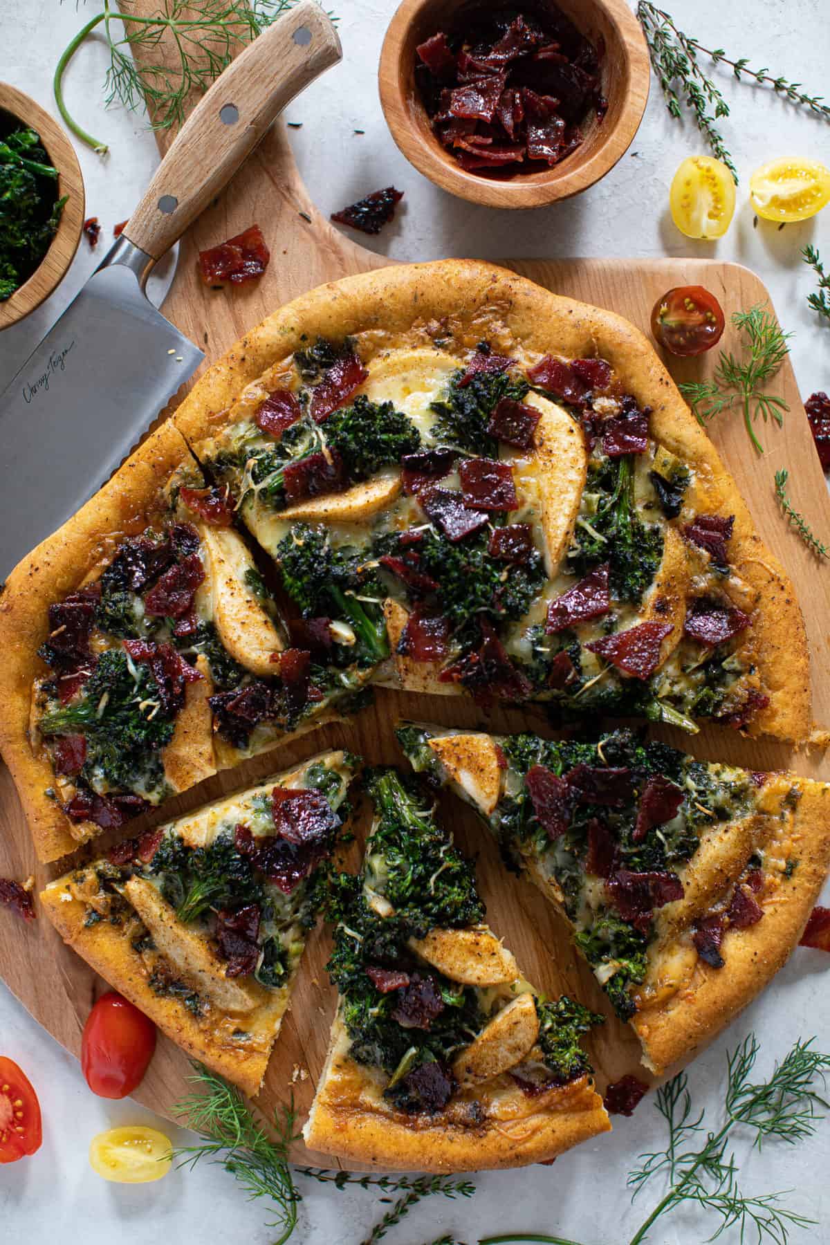 Partially-sliced Fall Harvest Pizza on a wooden board