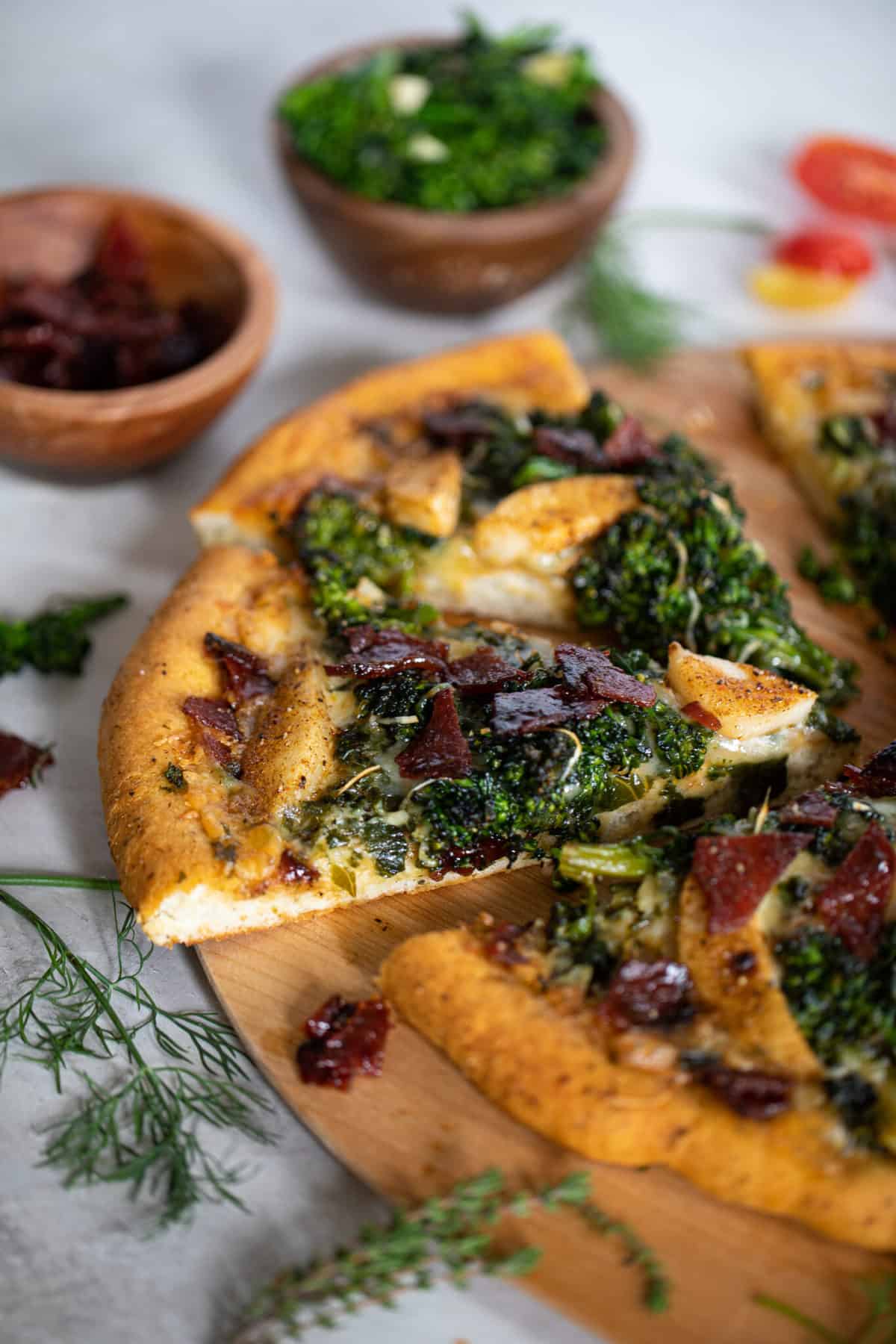 Slices of Fall Harvest Pizza on a wooden board.