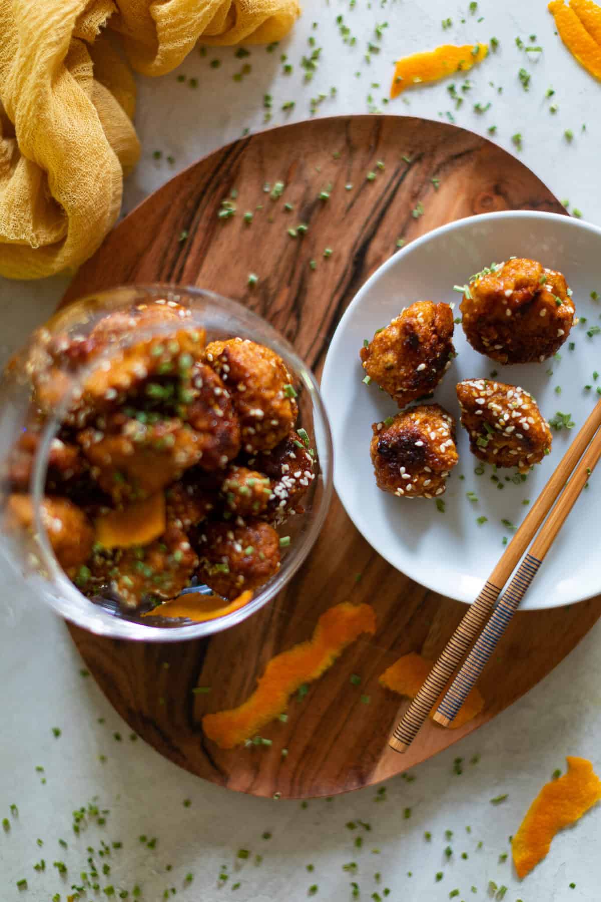 Crispy Baked Sticky Orange Cauliflower Bites in a bowl and on a plate.