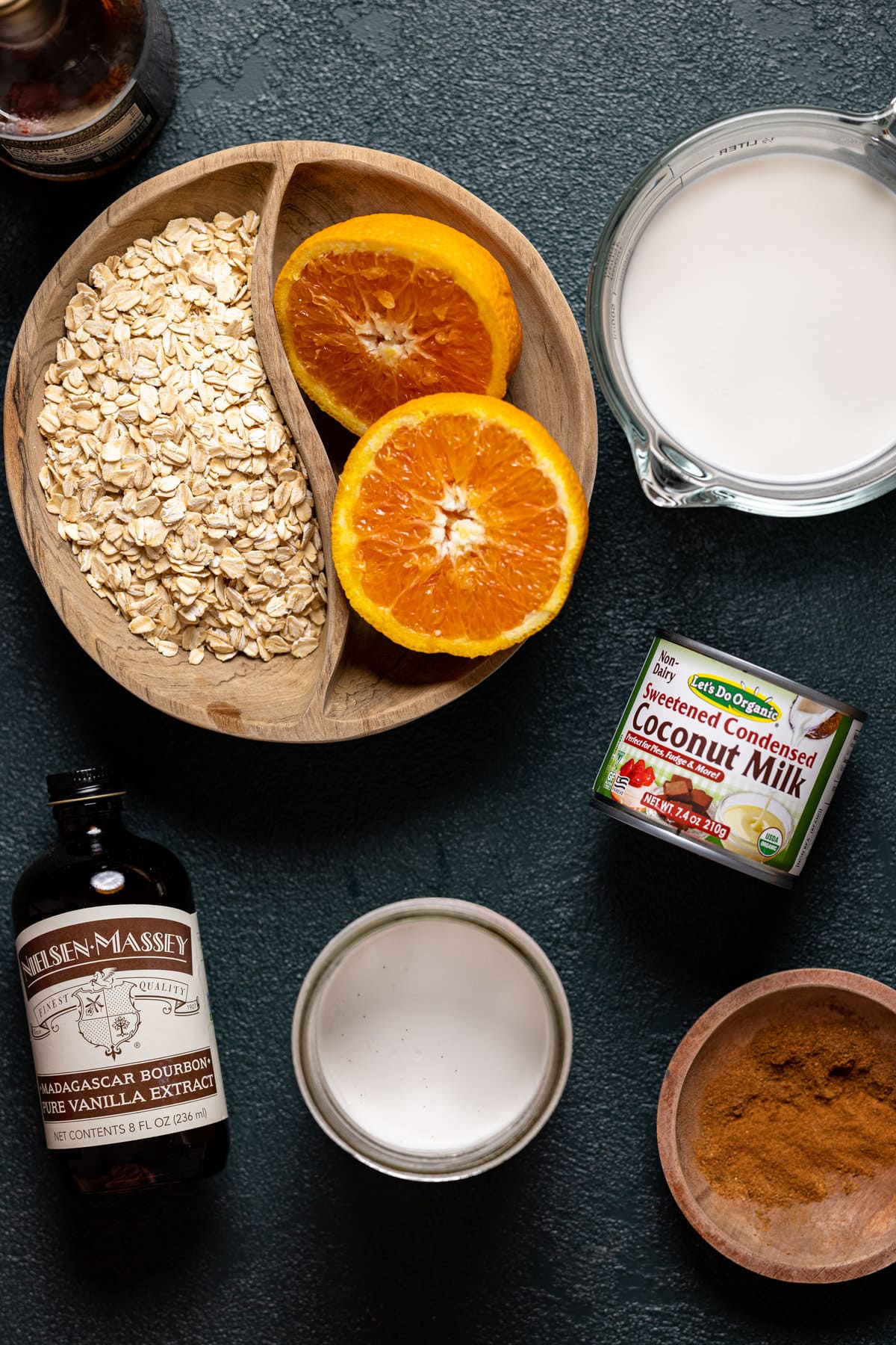 Ingredients for Maple Cinnamon Oatmeal with Roasted Oranges including vanilla extract, sweetened condensed coconut milk, and cinnamon