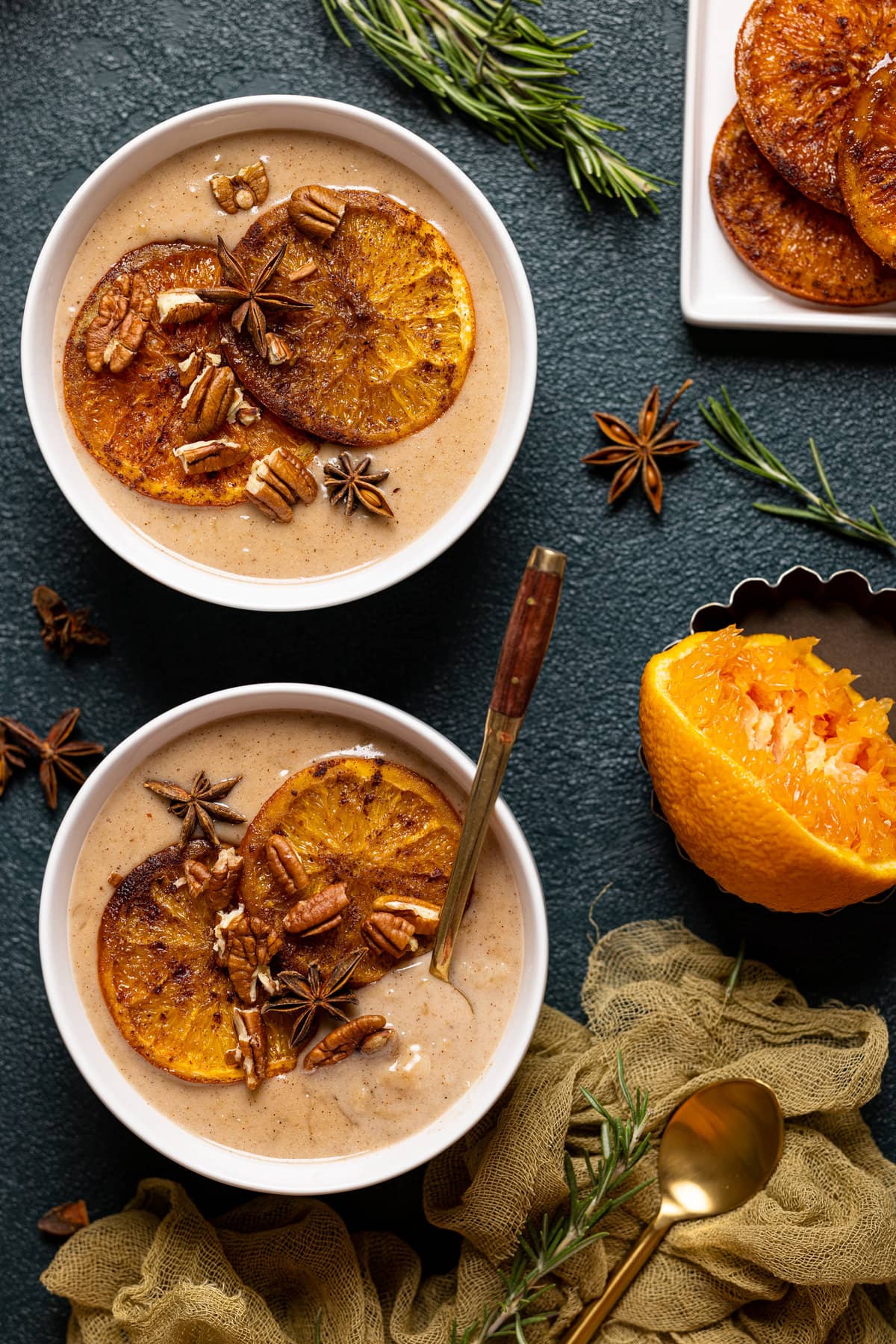 Overhead shot of two bowls of Maple Cinnamon Oatmeal with Roasted Oranges