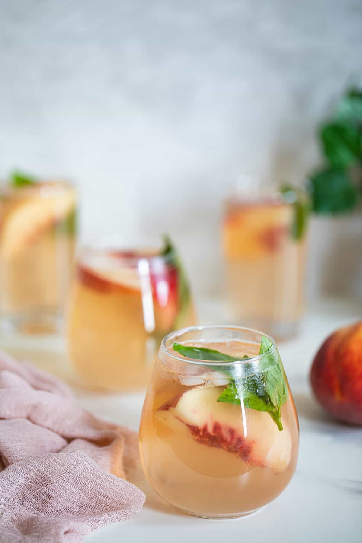 Peach basil drinks in small glasses.