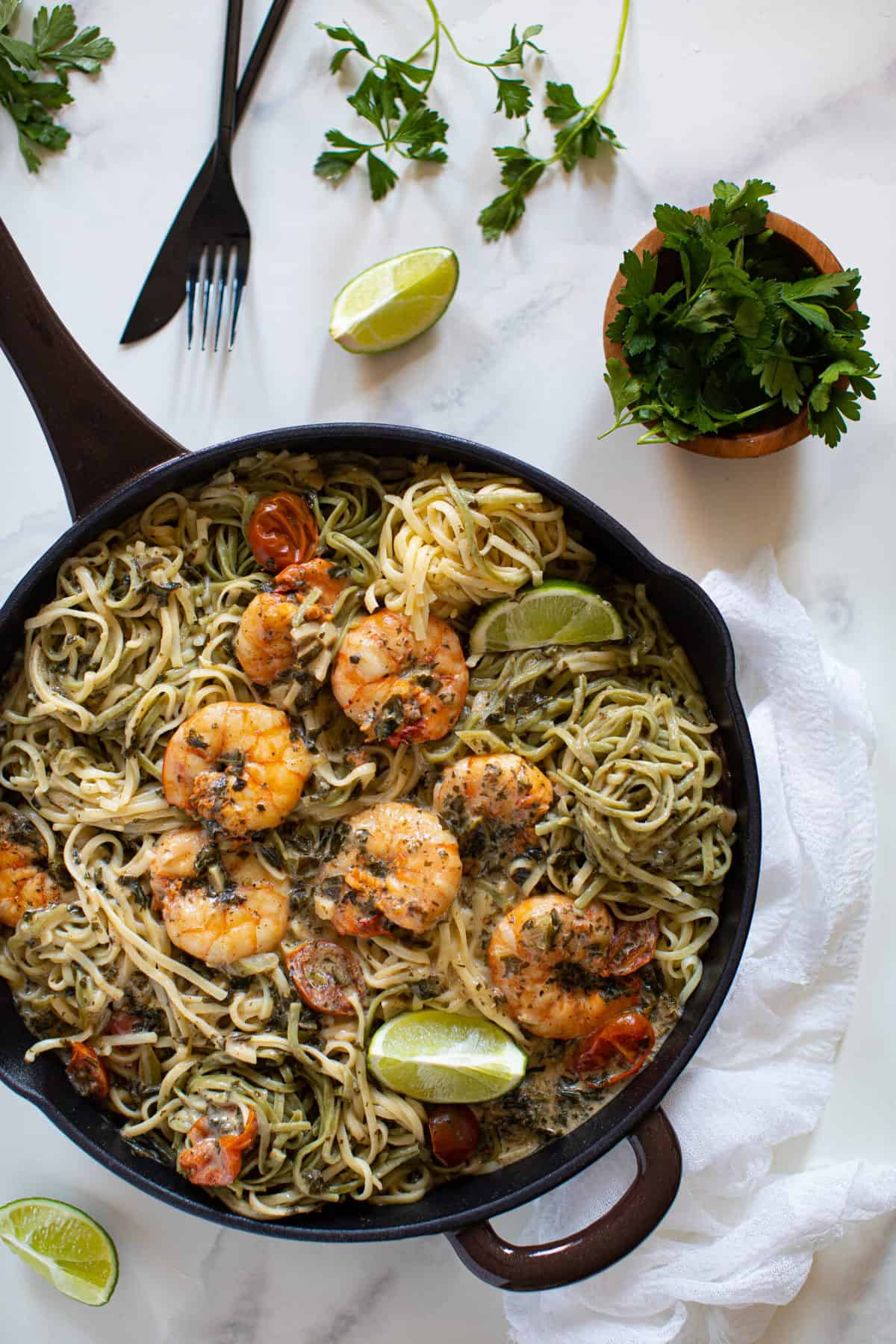 Cast-iron skillet of Gluten-Free Coconut Lime Shrimp Pasta.