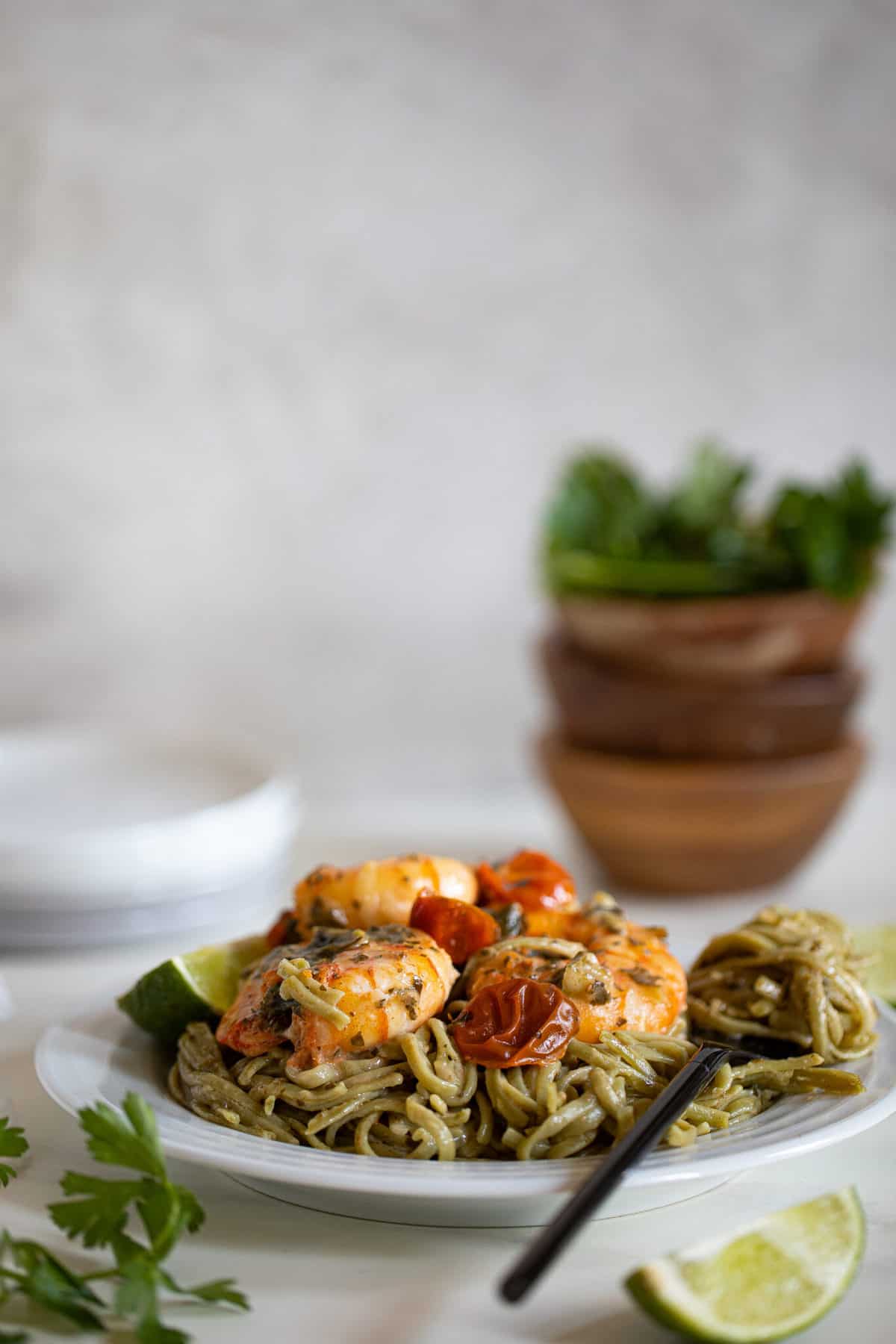 White plate of Gluten-Free Coconut Lime Shrimp Pasta.