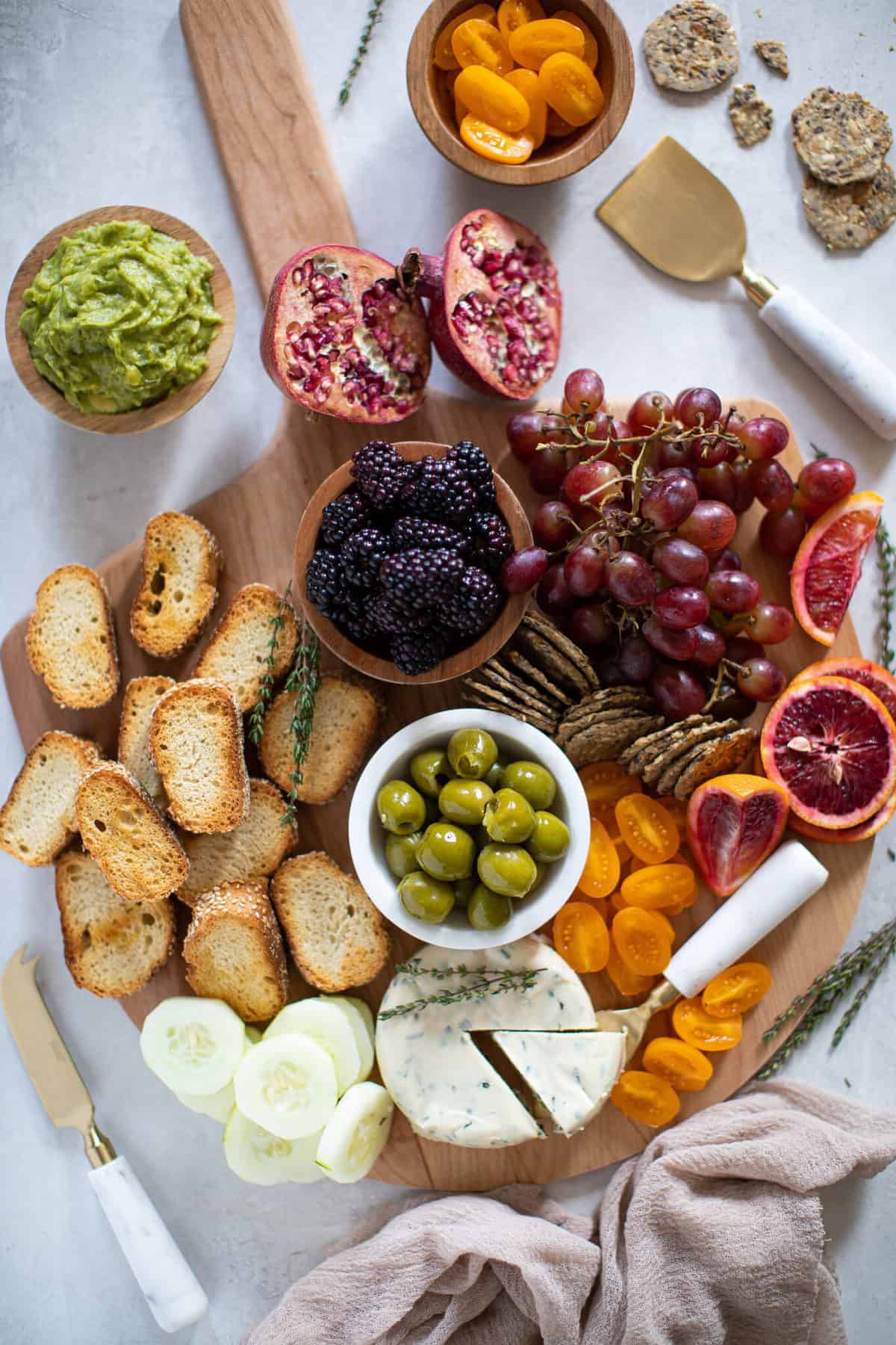 Full Charcuterie board including olives, bread, fruit, and crackers.