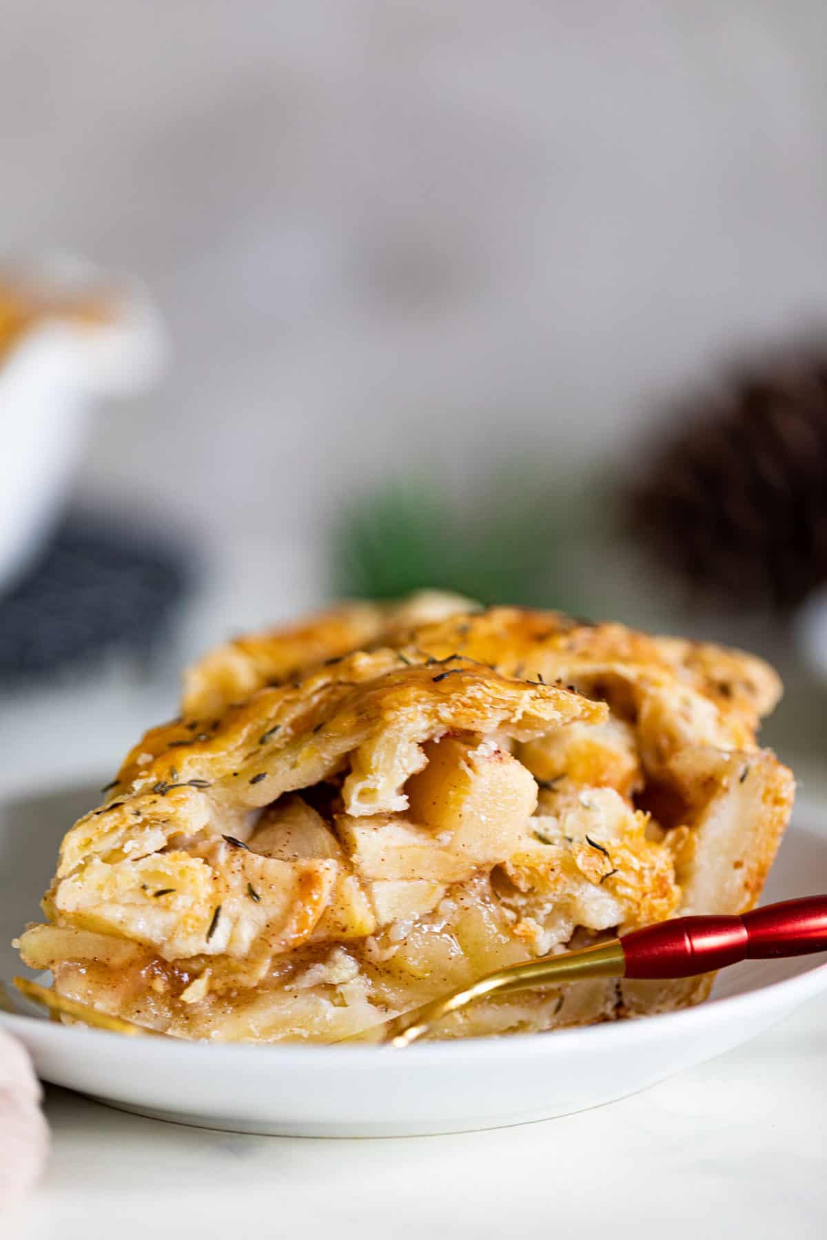 Slice of Apple Cheddar Thyme Pie on a plate