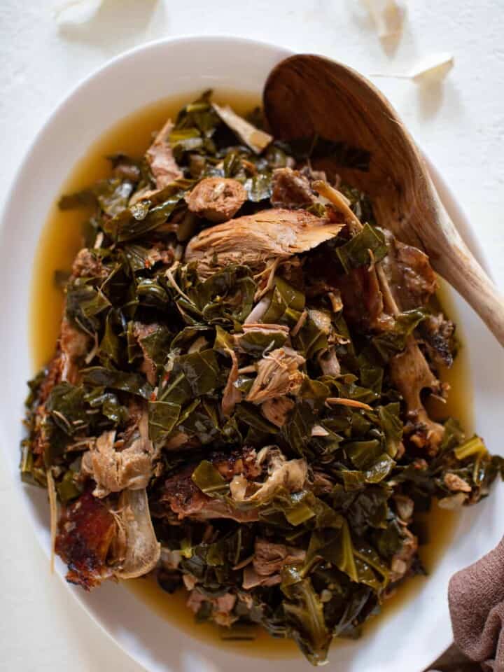 Wooden spoon in a large bowl of Leftover Turkey Southern Collard Greens