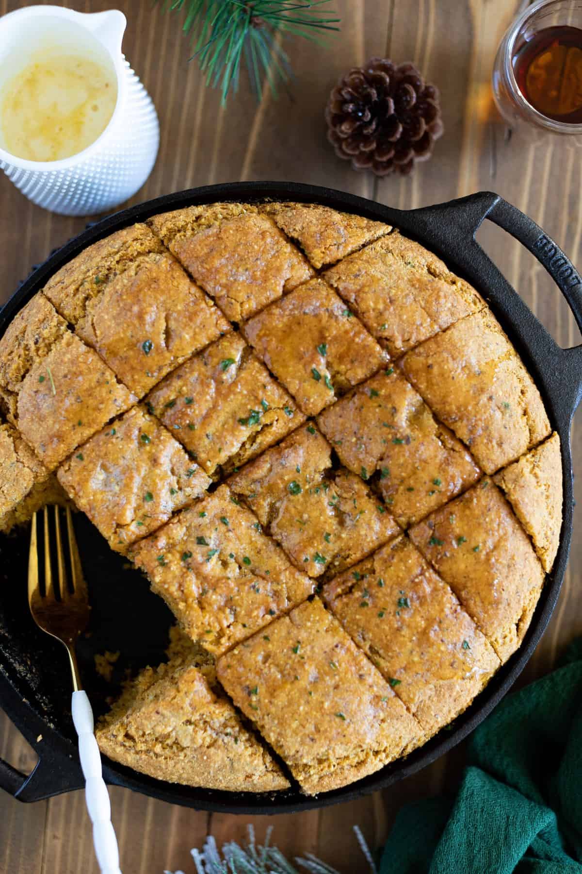 Sliced Vegan Sweet Potato Maple Herb Cornbread in a skillet.